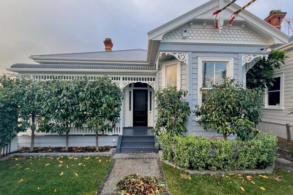 Front view of a freshly painted Mount Eden villa in a grey and blue colour scheme.