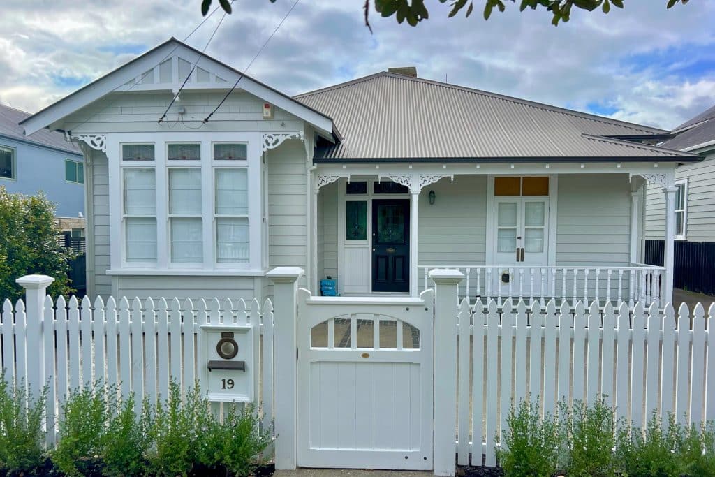 Completed exterior repaint of character villa in Sandringham, in Resene Narrowneck Half with white joinery and Resene Nero front door