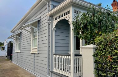 Corner view of a Mount Eden Villa that has been freshly painted in a grey and white colour scheme.